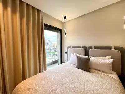 a bedroom with a large bed and a window at Centro 2 Bedrooms- By AppartAli in Casablanca