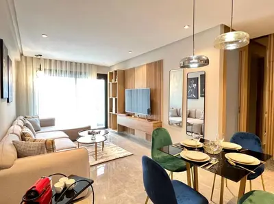 a living room with a couch and a table and chairs at Centro 2 Bedrooms- By AppartAli in Casablanca