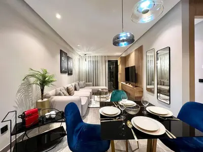 a living room with a couch and a table and chairs at Centro 2 Bedrooms- By AppartAli in Casablanca