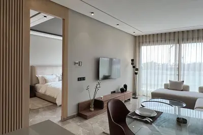 a living room with a bed and a table and a bedroom at Royal Suite by the Ocean - By Appartali in Casablanca