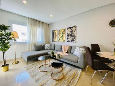 a living room with a couch and a table at Cosy Triangle D Or Bourgogne - By AppartAli in Casablanca