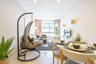 a living room with a hanging chair in a living room at Triangle D Or Bourgogne - By AppartAli in Casablanca