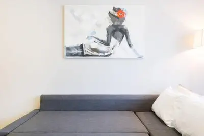 a bedroom with a bed with a painting on the wall at Triangle D Or Bourgogne - By AppartAli in Casablanca