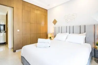 a bedroom with a large white bed in a room at Triangle D Or Bourgogne - By AppartAli in Casablanca