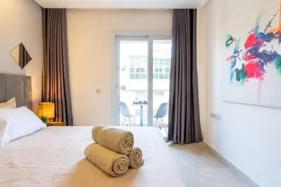 a bedroom with a bed with two towels on it at Triangle D Or Bourgogne - By AppartAli in Casablanca