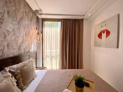 a bedroom with a bed and a large window at La Corniche Garden View - By AppartAli in Casablanca