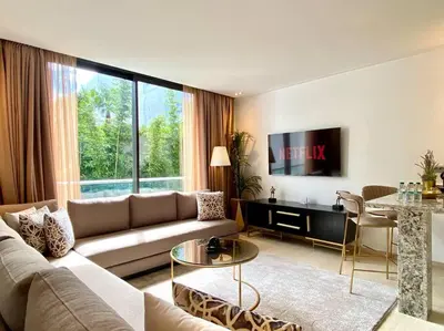 a living room with a couch and a table at La Corniche Garden View - By AppartAli in Casablanca