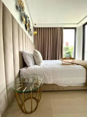 a bedroom with a bed and a glass table at La Corniche- Fab Design Ocean - By AppartAli in Casablanca