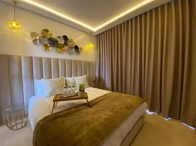 a bedroom with a large bed with a table on it at La Corniche- Fab Design Ocean - By AppartAli in Casablanca