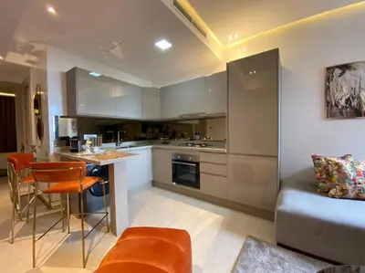 a kitchen with a couch and a table in a room at La Corniche- Fab Design Ocean - By AppartAli in Casablanca