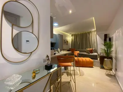 a bathroom with a sink and a living room at La Corniche- Fab Design Ocean - By AppartAli in Casablanca