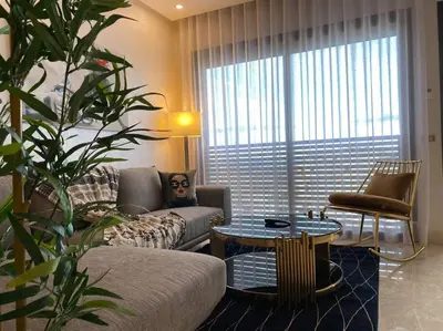 a living room with a couch and a table at Mogador Presidential Terrace - By AppartAli in Casablanca