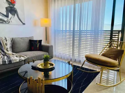 a living room with a couch and a table at Mogador Presidential Terrace - By AppartAli in Casablanca