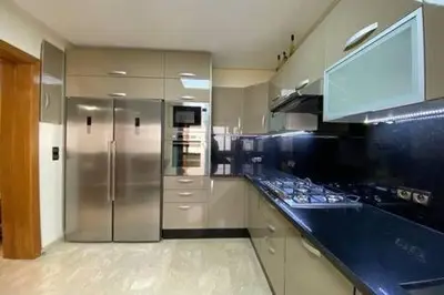a kitchen with a stainless steel refrigerator and a counter at Familial Boulevard D Anfa - By AppartAli in Casablanca