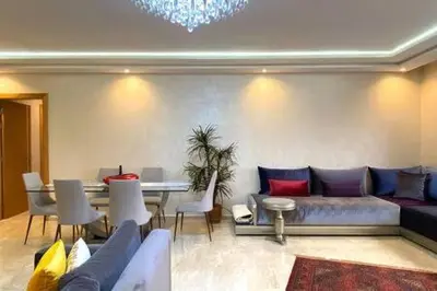 a living room with a couch and a table at Familial Boulevard D Anfa - By AppartAli in Casablanca