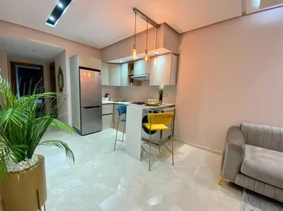 a kitchen with a couch and a table in a room at Charming Top Floor Bourgogne - By AppartAli in Casablanca