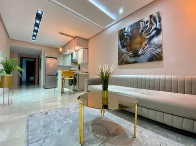 a living room with a couch and a painting of a tiger at Charming Top Floor Bourgogne - By AppartAli in Casablanca