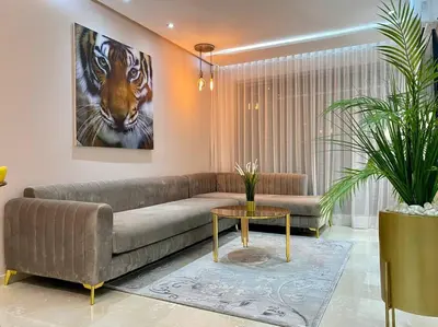 a living room with a couch and a picture of a tiger at Charming Top Floor Bourgogne - By AppartAli in Casablanca