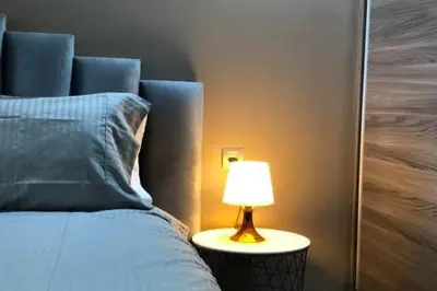 a bed with a lamp on a table next to it at Contemporary Top Floor Bourgogne - By AppartAli in Casablanca