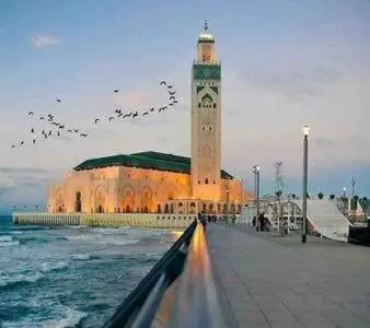 a building with a clock tower next to the ocean at Contemporary Top Floor Bourgogne - By AppartAli in Casablanca