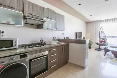 a kitchen with a stove and a dishwasher at Contemporary Top Floor Bourgogne - By AppartAli in Casablanca