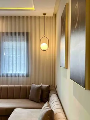 a living room with a couch and a window at Lovely Anfa City - By AppartAli in Casablanca