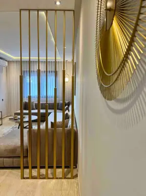 a bedroom with a bed with a gold gate at Lovely Anfa City - By AppartAli in Casablanca