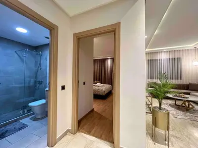 a room with a bathroom with a toilet and a bedroom at Lovely Anfa City - By AppartAli in Casablanca