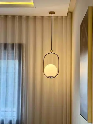 aendant light hanging from a wall next to a window at Lovely Anfa City - By AppartAli in Casablanca