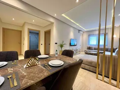 a living room with a dining table and a bedroom at Lovely Anfa City - By AppartAli in Casablanca