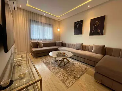 a living room with a couch and a coffee table at Lovely Anfa City - By AppartAli in Casablanca