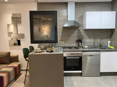 a kitchen with a stove and a counter top at Faubourgs D Anfa Suite - By AppartAli in Casablanca