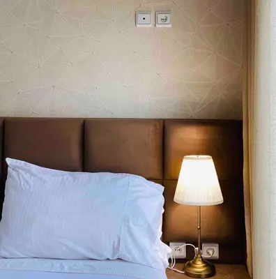 a bed with a white pillow and a lamp next to it at Sunny OASIS 2 Bedrooms - By AppartAli in Casablanca