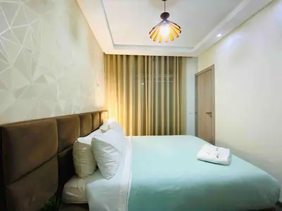 a bedroom with a large bed and a light at Sunny OASIS 2 Bedrooms - By AppartAli in Casablanca