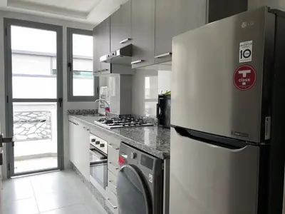 a kitchen with a refrigerator and a stove at Sunny OASIS 2 Bedrooms - By AppartAli in Casablanca
