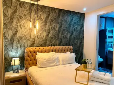 a bedroom with a large bed with a wall at Racine Zara Street - By AppartAli in Casablanca