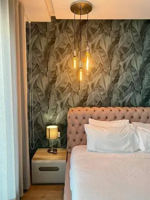 a bedroom with a large bed and a wall with at Racine Zara Street - By AppartAli in Casablanca
