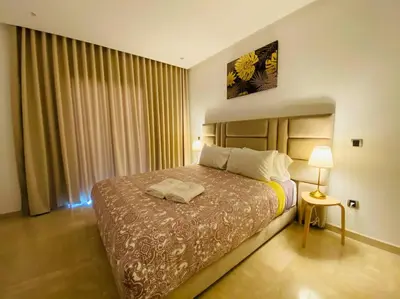 a bedroom with a large bed and a window at Maarif City Sunrise- 3 Beds - By AppartAli in Casablanca