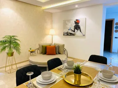 a living room with a table and a couch at Maarif City Sunrise- 3 Beds - By AppartAli in Casablanca