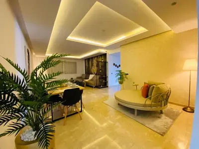 a living room with a yellow couch and a table at Maarif City Sunrise- 3 Beds - By AppartAli in Casablanca