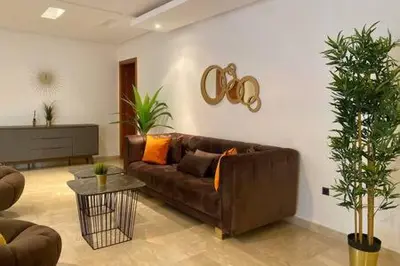 a living room with a brown couch and a table at Maarif Sunset View - 3 Bedrooms - By AppartAli in Casablanca