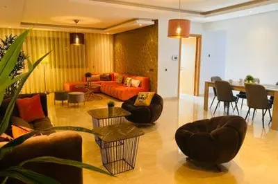a living room with a couch and chairs and a table at Maarif Sunset View - 3 Bedrooms - By AppartAli in Casablanca