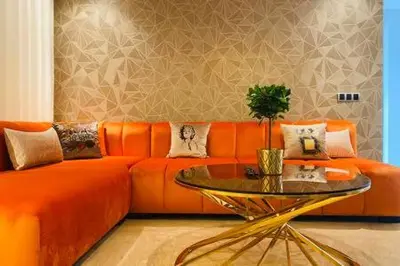 a living room with an orange couch and a glass table at Maarif Sunset View - 3 Bedrooms - By AppartAli in Casablanca