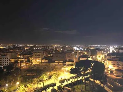 a city lit up at night with buildings and palm trees at Maarif Top Floor - 2 Bedrooms - By AppartAli in Casablanca