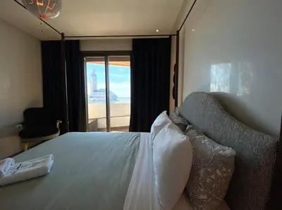 a bedroom with a bed with a couch and a window at The view - Marina 2 Beds - By AppartAli in Casablanca