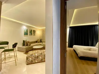 a hotel room with a bed and a living room at Deluxe Princesses Design - By AppartAli in Casablanca