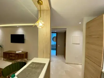 a living room with a table and a tv at Deluxe Princesses Design - By AppartAli in Casablanca