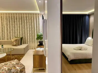 a hotel room with a bed and a living room at Deluxe Princesses Design - By AppartAli in Casablanca
