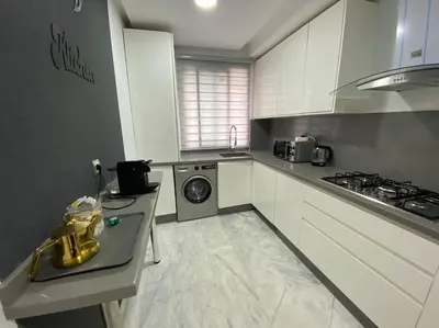 a kitchen with a stove and a washing machine at Corniche Casablanca - Red’s Neuf in Casablanca