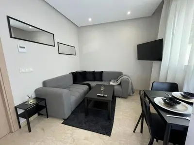 a living room with a couch and a table at Modern Cosy Studio Anfa in Casablanca